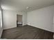 Spacious bedroom with gray vinyl flooring and bathroom access at 38007 W Mcdowell Rd, Tonopah, AZ 85354