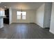 Bright dining room with gray vinyl flooring and kitchen access at 38007 W Mcdowell Rd, Tonopah, AZ 85354