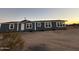 Blue manufactured home with white trim and sun setting at 38007 W Mcdowell Rd, Tonopah, AZ 85354