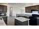 Open kitchen with dark wood cabinets and granite countertops at 38007 W Mcdowell Rd, Tonopah, AZ 85354