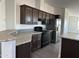 Modern kitchen with dark wood cabinets and stainless steel appliances at 38007 W Mcdowell Rd, Tonopah, AZ 85354