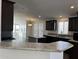 Modern kitchen with dark brown cabinets and granite countertops at 38007 W Mcdowell Rd, Tonopah, AZ 85354