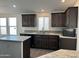 Modern kitchen with dark wood cabinets and granite countertops at 38007 W Mcdowell Rd, Tonopah, AZ 85354