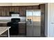 Kitchen with dark wood cabinets and granite countertops at 38007 W Mcdowell Rd, Tonopah, AZ 85354