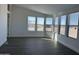 Bright living room featuring gray vinyl flooring and multiple windows at 38007 W Mcdowell Rd, Tonopah, AZ 85354