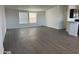 Spacious living room with gray vinyl flooring and kitchen view at 38007 W Mcdowell Rd, Tonopah, AZ 85354