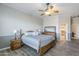 Main bedroom with wood bed frame and ceiling fan at 3888 E Hazeltine Way, Chandler, AZ 85249