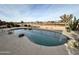 Kidney shaped pool with surrounding landscaping and a golf course view at 3888 E Hazeltine Way, Chandler, AZ 85249