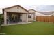 Covered patio, artificial turf, and wood fence at 3907 S 78Th Ln, Phoenix, AZ 85043