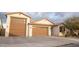 Two-car garage, light-colored brick exterior, and a well-maintained front yard at 3907 S 78Th Ln, Phoenix, AZ 85043