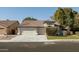 Single-story home with a two-car garage and well-manicured lawn at 3950 S Cactus Wren Dr, Chandler, AZ 85248