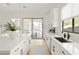 Modern white kitchen with stainless steel appliances and large island at 3950 S Cactus Wren Dr, Chandler, AZ 85248