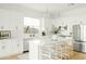 Bright white kitchen with center island and stainless steel appliances at 3950 S Cactus Wren Dr, Chandler, AZ 85248