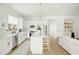 Modern white kitchen with island, stainless steel appliances, and light wood floors at 3950 S Cactus Wren Dr, Chandler, AZ 85248