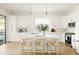 White kitchen with island, stainless steel appliances, and pendant lights at 3950 S Cactus Wren Dr, Chandler, AZ 85248