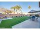 Artificial turf backyard with patio furniture and umbrella at 4340 E Silverbell Rd, San Tan Valley, AZ 85143