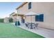 Backyard patio with table, chairs, and umbrella at 4340 E Silverbell Rd, San Tan Valley, AZ 85143