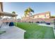 Landscaped backyard with artificial turf, patio, and seating area at 4340 E Silverbell Rd, San Tan Valley, AZ 85143