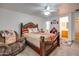 Bedroom with a dark wood bed frame and adjacent bathroom at 4340 E Silverbell Rd, San Tan Valley, AZ 85143