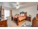 Bedroom with a dark wood bed frame and ceiling fan at 4340 E Silverbell Rd, San Tan Valley, AZ 85143