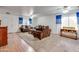 Living room with brown sofas and a view of a home office and entryway at 4340 E Silverbell Rd, San Tan Valley, AZ 85143