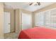 Bedroom with a full bed, ceiling fan, window shutters, and coral bedding at 4611 E Red Bird Rd, Cave Creek, AZ 85331