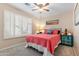 Bedroom with a full bed, ceiling fan, window shutters, and teal accents at 4611 E Red Bird Rd, Cave Creek, AZ 85331