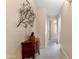 Bright hallway with tile flooring, decorative wall art, and a wooden accent table at 4611 E Red Bird Rd, Cave Creek, AZ 85331