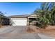 Single-story house with a white garage door and landscaping at 4718 N 193Rd Dr, Litchfield Park, AZ 85340