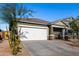 Single-story house with a white garage door and landscaping at 4718 N 193Rd Dr, Litchfield Park, AZ 85340