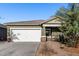 Single-story house with a white garage door and landscaping at 4718 N 193Rd Dr, Litchfield Park, AZ 85340