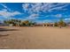 Large gravel backyard with distant home view at 4805 W Saguaro Park Ln, Glendale, AZ 85310