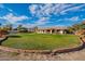 Large backyard with brick border and green lawn at 4805 W Saguaro Park Ln, Glendale, AZ 85310