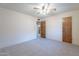 Bright bedroom with carpeted floor, ceiling fan, and ample closet space at 4805 W Saguaro Park Ln, Glendale, AZ 85310