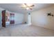 Large bedroom with ceiling fan and access to another room at 4805 W Saguaro Park Ln, Glendale, AZ 85310