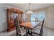 Dining room with wood table and chairs, and a hutch at 4805 W Saguaro Park Ln, Glendale, AZ 85310