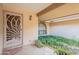 Covered entryway with decorative door and lush landscaping at 4805 W Saguaro Park Ln, Glendale, AZ 85310