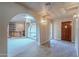 Bright entryway with tile floors and views into the living room and kitchen at 4805 W Saguaro Park Ln, Glendale, AZ 85310