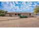 Front view of a single story home with desert landscaping at 4805 W Saguaro Park Ln, Glendale, AZ 85310