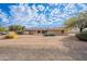 Single-story home exterior with landscaped yard and desert landscaping at 4805 W Saguaro Park Ln, Glendale, AZ 85310