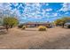 Side view of the house with gravel driveway at 4805 W Saguaro Park Ln, Glendale, AZ 85310