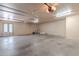 Spacious garage featuring overhead storage and two garage doors at 4805 W Saguaro Park Ln, Glendale, AZ 85310