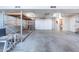 Interior view of a garage with storage shelving and a garage door at 4805 W Saguaro Park Ln, Glendale, AZ 85310