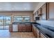 Spacious kitchen with granite countertops, wood cabinets, and stainless steel appliances at 4805 W Saguaro Park Ln, Glendale, AZ 85310