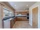 Kitchen with wood cabinets, granite counters, and stainless steel appliances at 4805 W Saguaro Park Ln, Glendale, AZ 85310