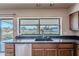 Kitchen features granite countertops, wood cabinets, and a view of the backyard at 4805 W Saguaro Park Ln, Glendale, AZ 85310