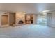 Living room with brick fireplace, built-in shelving, and hardwood floors at 4805 W Saguaro Park Ln, Glendale, AZ 85310