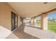 Spacious covered patio with grassy backyard views at 4805 W Saguaro Park Ln, Glendale, AZ 85310