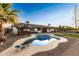 Charming backyard oasis featuring a pool and tiki hut at 5732 W Purdue Ave, Glendale, AZ 85302