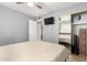 Spacious bedroom with a king-size bed and mirrored closet doors at 5732 W Purdue Ave, Glendale, AZ 85302